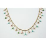 A GOLD, TURQUOISE AND ENAMEL DROP NECKLACE formed alternately with white enamel and red guilloche