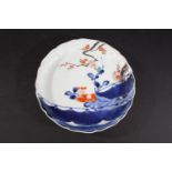 JAPANESE KAKIEMON DISH a lobbed dish painted with tree blossom in blue, red and white colours. Bears