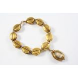 A VICTORIAN GOLD BRACELET formed with oval links with reeded decoration, suspending a locket