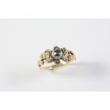 A GEORGIAN DIAMOND RING the rose-cut diamond is set in silver, with gold scrolling shoulders. Size N