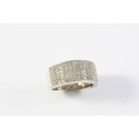 A DIAMOND HALF HOOP RING mounted with six rows of circular-cut diamonds, in white gold. Size K 1/2