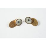 A PAIR OF MOTHER OF PEARL AND 15CT GOLD CUFFLINKS each formed with a circular mother of pearl link