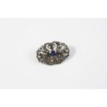 A VICTORIAN SAPPHIRE AND DIAMOND BROOCH the openwork foliate mount is centred with an oval-shaped