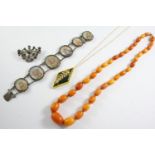 ASSORTED JEWELLERY including a graduated oval-shaped amber bead necklace, 54cm long, 31 grams, a