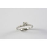 A DIAMOND SOLITAIRE RING set with a circular brilliant-cut diamond, in white gold. Size N
