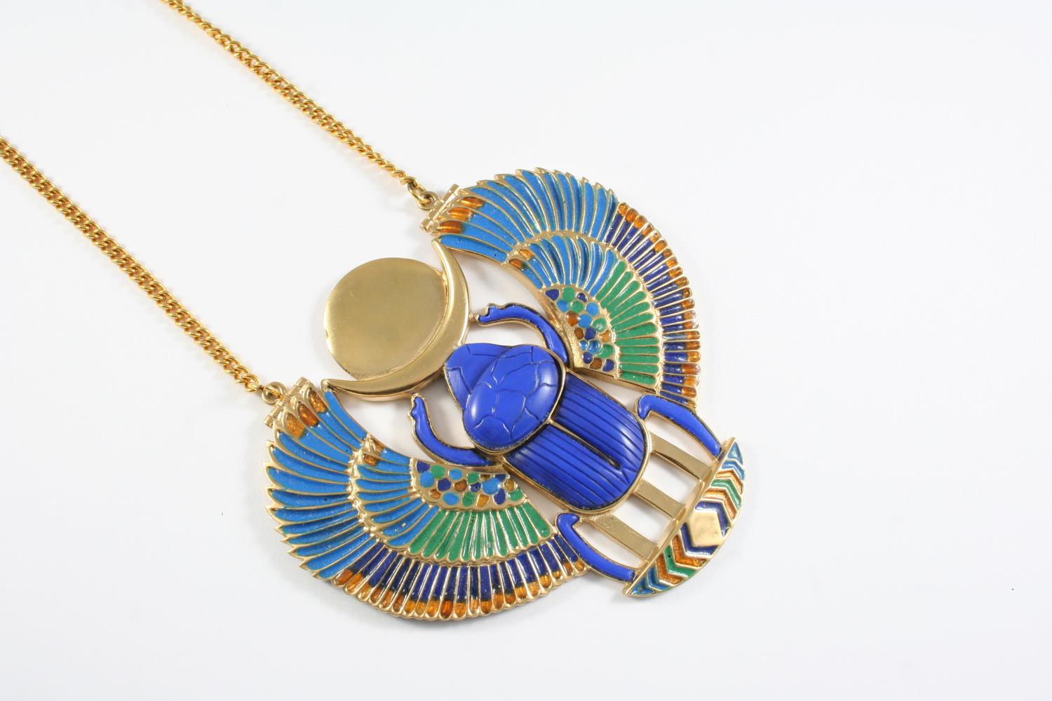 A TUTANKHAMUN SCARAB NECKLACE AND CUFF with enamel decoration, the necklace 11.4cm wide, the cuff