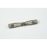 A FRENCH DIAMOND AND PEARL BOW BROOCH the openwork mount set overall with rose-cut diamonds and