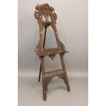 MOORISH ARTIST EASEL early 20thc, a hardwood easel with carved and inlaid decoration and bobbin