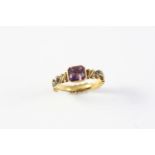 A GEORGE II AMETHYST SET MOURNING RING the amethyst set in gold closed back setting, with black