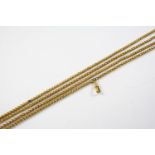 AN ANTIQUE PINCHBECK LONG GUARD CHAIN formed with pierced hollow links, 132cm long