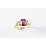 A DIAMOND AND SPINEL THREE STONE RING the rectangular-shaped red spinel is set with two brilliant-