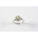 A DIAMOND CLUSTER RING the circular-cut diamond is set within a surround of eight smaller circular-