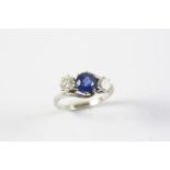 A SAPPHIRE AND DIAMOND THREE STONE RING the circular-cut sapphire is set with two brilliant-cut