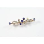 A EARLY 20TH CENTURY SAPPHIRE, DIAMOND AND PEARL BROOCH the scrolling foliate design is mounted with