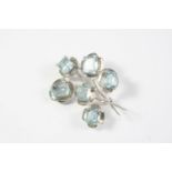 AN AQUAMARINE FOLIATE SPRAY BROOCH mounted with six graduated step-cut aquamarines in 9ct white