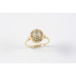 A DIAMOND CLUSTER RING the central rose-cut diamond is set within a surround of small rose-cut