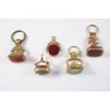 FIVE ASSORTED SEALS including one formed as a snake with citrine matrix engraved with initials,