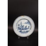 18THC DELFT DISH a blue and white dish painted with buildings within an oriental style landscape,