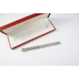 A SILVER BALLPOINT PEN BY MUST DE CARTIER with engine turned decoration, signed Cartier, Paris, 14cm