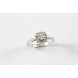 A DIAMOND CLUSTER RING the circular brilliant-cut diamond is set within a surround of twelve