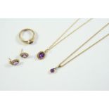 AN AMETHYST AND DIAMOND PENDANT the pear-shaped amethyst is set with a circular-cut diamond in gold,