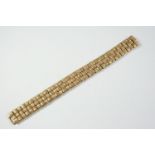 A 9CT GOLD BRACELET of textured woven design, with concealed clasp, 18.2cm long, 41.7 grams