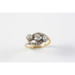 A DIAMOND THREE STONE RING the three circular old-cut diamonds are set with further diamonds to