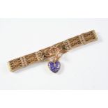 A 9CT GOLD FANCY GATE LINK BRACELET suspending a heart-shaped blue enamel charm with gold