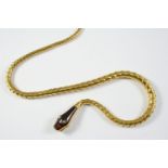 A VICTORIAN GARNET AND GOLD SNAKE NECKLACE the garnet head with rose-cut diamond eyes, set to a