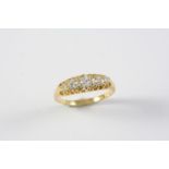 A DIAMOND FIVE STONE RING the five graduated old circular-cut diamonds are set in yellow gold.
