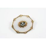 A VICTORIAN CHALCEDONY AND GOLD MOURNING BROOCH the chalcedony with applied gold and foliate