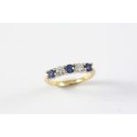 A SAPPHIRE AND DIAMOND FIVE STONE RING the three circular-cut sapphires are set with two circular-