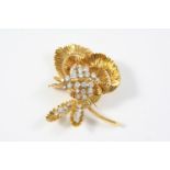 A DIAMOND AND GOLD FOLIATE SPRAY BROOCH BY KUTCHINSKY the 18ct gold textured mount set with