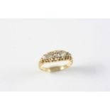 A DIAMOND FIVE STONE RING the five graduated old-cut diamonds are set in yellow gold. Size M