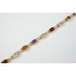 AN 18CT GOLD AND GEM SET BRACELET mounted with assorted rectangular-shaped gem stones, including