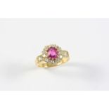 A PINK SAPPHIRE AND DIAMOND CLUSTER RING the oval-shaped pink sapphire is set within a surround of