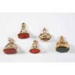 FIVE ASSORTED GOLD SEALS three with carnelian matrixes, one engraved with initials, 3cm high one