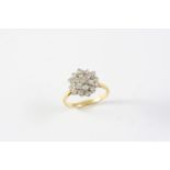 A DIAMOND CLUSTER RING set overall with circular-cut diamonds in 18ct gold. Size J 1/2