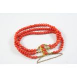 A THREE ROW UNIFORM CORAL BEAD BRACELET the coral beads are set to a gold rectangular-shaped