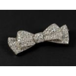 AN ART DECO DIAMOND BOW BROOCH set overall with graduated old circular-cut diamonds, in platinum,