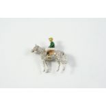 A DIAMOND AND ENAMEL STANDING HORSE AND JOCKEY BROOCH set overall with circular-cut diamonds, the