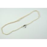 A SINGLE ROW GRADUATED NATURAL PEARL NECKLACE the one hundred and seven pearls graduate from 2.5mm