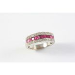 A RUBY AND DIAMOND RING set with a row of calibre-cut rubies within a border of circular-cut