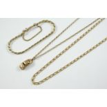 A 9CT GOLD LONG CURB LINK NECKLACE 60cm. long, together with a 9ct gold bracelet and a 9ct gold