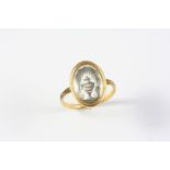 A GEORGE III GOLD, SEPIA AND BLACK ENAMEL MOURNING RING depicting an urn under a tree, with