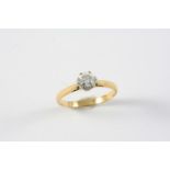 A DIAMOND SOLITAIRE RING the circular-cut diamond is set in 18ct yellow gold. Size P 1/2