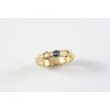 A SAPPHIRE AND GOLD RING BY TIFFANY & CO. the yellow gold shank with 'Tiffany kiss' decoration and