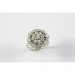 A DIAMOND CLUSTER RING the central cluster of circular-cut diamonds is set within an outer