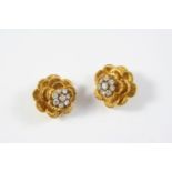 A PAIR OF GOLD AND DIAMOND FLOWERHEAD CLIP EARRINGS BY KUTCHINSKY each set with a central cluster of