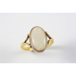 AN OPAL AND GOLD RING the oval-shaped solid white opal is set in 22ct gold. Size V